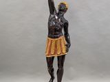 a statue of a woman holding a basket of flowers on a table