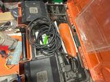 an orange box with tools in it sitting on a table