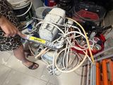 a woman that is working on a machine in a room