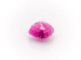 a close up of a pink diamond on a white surface