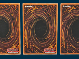 three cards with black and orange swirls on them on a blue background
