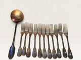 a lot of spoons and forks that are on the table