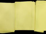 four folded yellow napkins on a black background
