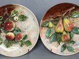 deux assiettes sur lesquelles sont peints des fruits, posées sur une table