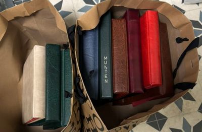a brown paper bag filled with books on a tiled floor