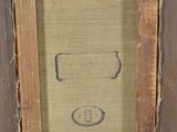 an old picture frame with a drawing of a man ' s face on it