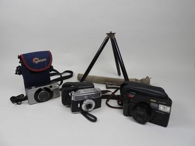 a camera, a tripod, a camera bag, and a camera on a tripod