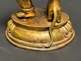 a gold statue of a person with a mouse on it