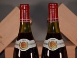 two bottles of wine sitting next to each other on a table