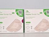 three boxes of breast pads sitting on top of a white table