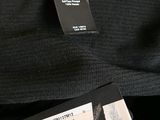 a label on the back of a bag that has a tag attached to it