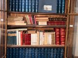 many books on the shelves in the case