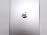 an apple ipad sitting on top of a white table next to a white wall