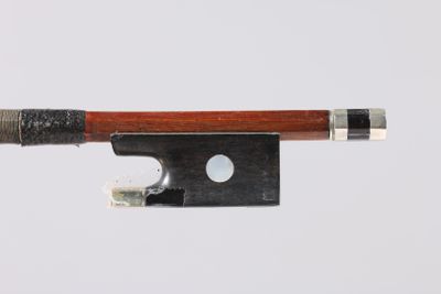 violin bow made of wood and metal on a white background