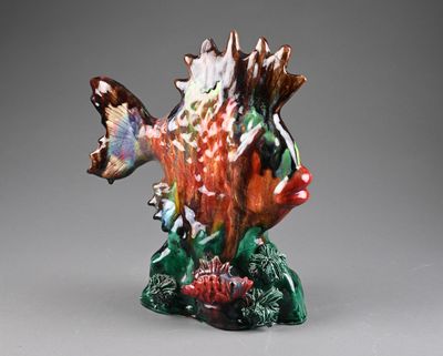 a figurine of a fish that is sitting on a table