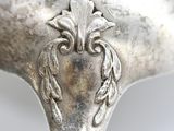 a close up of a silver spoon on a table