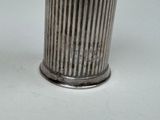 a silver vase that is sitting on a table