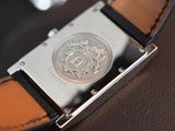 a close up of a watch on a brown leather strap