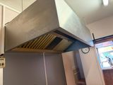 an image of a kitchen with a stove and a hood