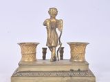 a statue of a woman holding a cane and two vases