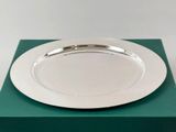 a silver plate sitting on top of a green box