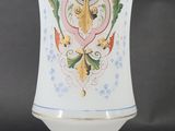 a white vase with a design on it on a table