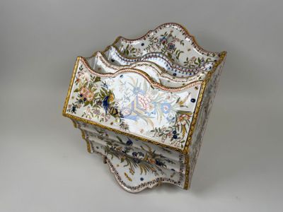 a decorative box with flowers on it sitting on a table