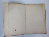 an open book with writing on it sitting on top of a table