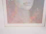 a painting of a woman ' s face in a white frame
