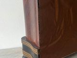 a small brown piece of furniture sitting on a table