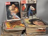 several magazines are stacked on top of each other on a table