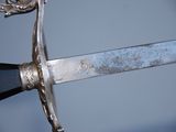 a close up of a sword with a metal handle