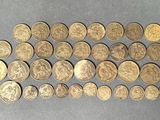a bunch of coins sitting on top of a table next to each other
