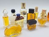 many different types of perfume bottles on a white surface