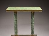 a green marble table with two columns on top of it