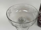 a glass bowl and a bottle sitting on a table