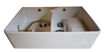 a white sink with a faucet and a faucet in it
