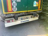 a green and yellow truck that is parked on the side of the road