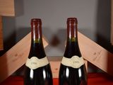 two bottles of wine sitting next to each other on a table