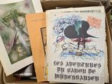 a box full of books and papers on a table