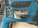 a close up of a corded drill on a table