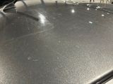 a close up of a car ' s hood with a lot of scratches on it