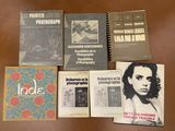 several books are sitting on a table next to each other