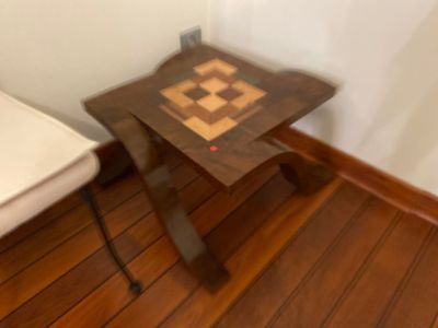 a small wooden table with a chess board on it