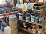 many rolls of paper on a shelf in a room