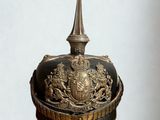 a helmet on top of a cork with a crown on it