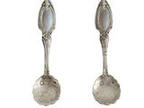 pair of sterling spoons with mother of pearl in the center