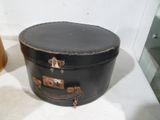 a black suitcase sitting on a white surface next to a lamp