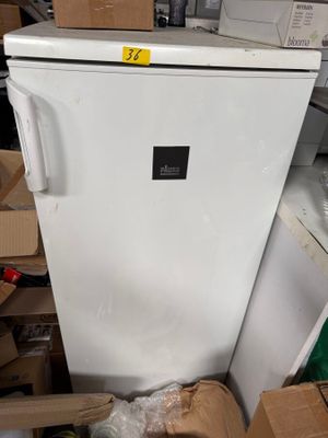 a white refrigerator in the middle of a pile of boxes