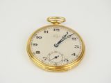 a close up of a pocket watch on a white surface